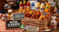 Dutch snack bar products on a wooden table with promotional signs.